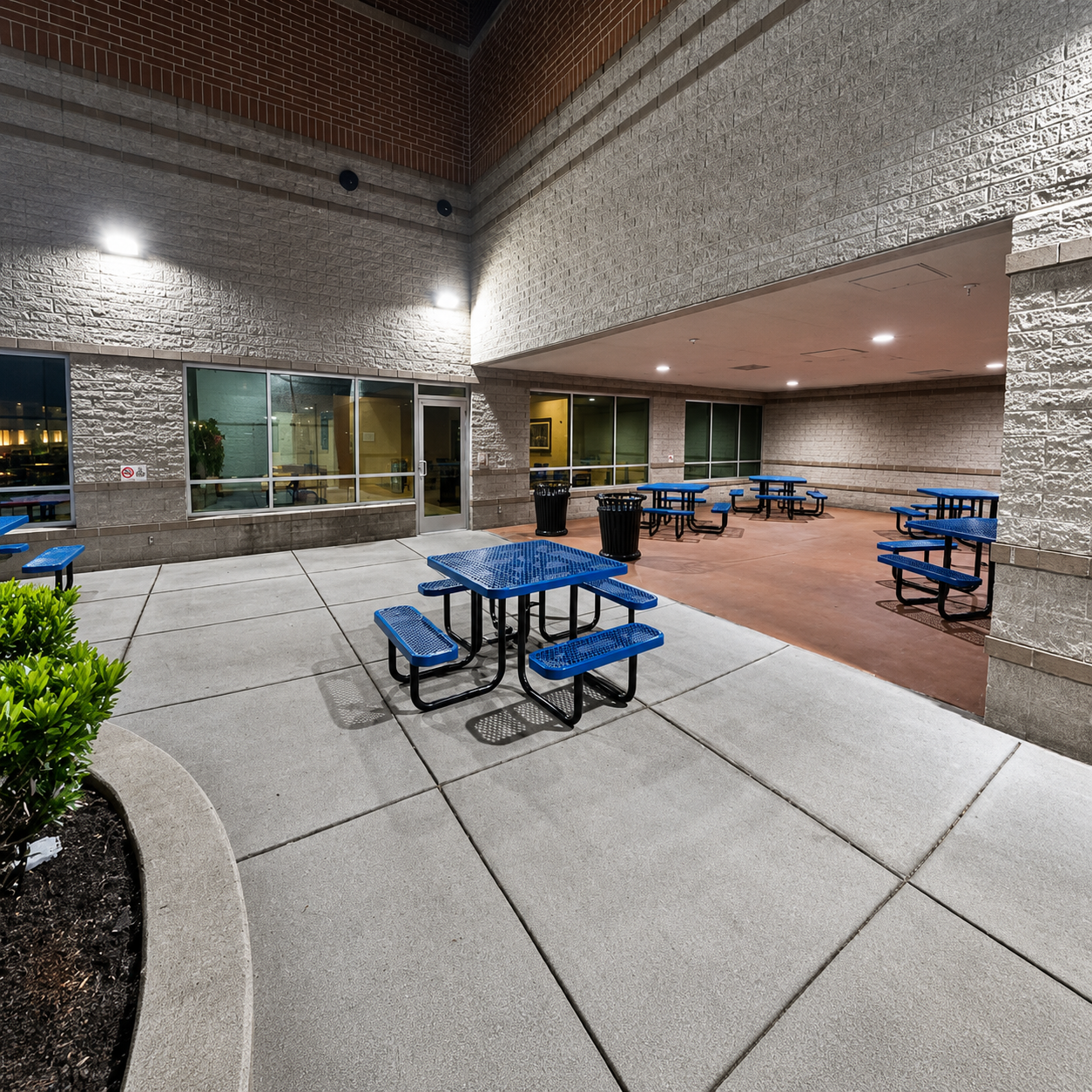 Commercial courtyard illuminated with outdoor wall mounted lighting